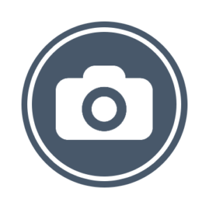 A slate blue circle with a white camera icon in the middle