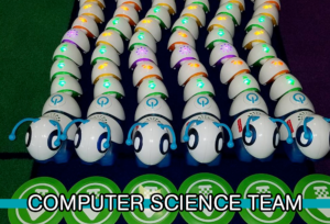Six brightly-lit multi-colored robotic caterpillars snake in parallel, with the words "Computer Science Team" at the bottom.